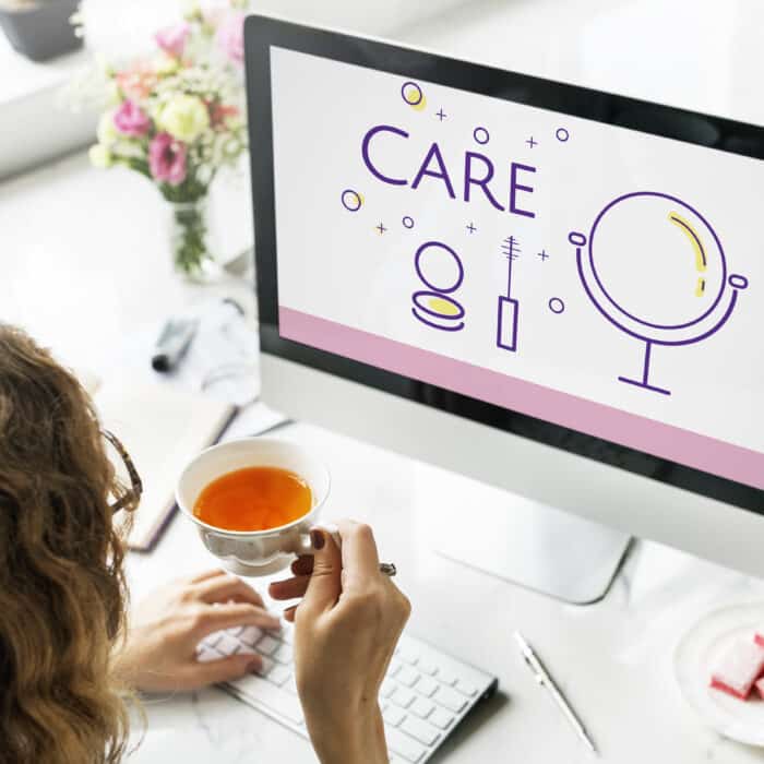 a women looking at a laptop working on WordPress Care Plans