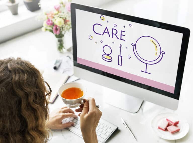 a women looking at a laptop working on WordPress Care Plans